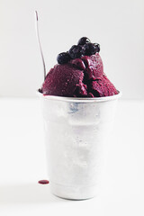 Acai ice cream and blueberries  on white background. Flat lay, top view. Spring, summer concept.
