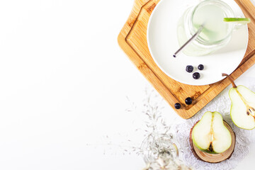Aesthetic minimalist composition. Glass with green lemonade on white background. Summer cold drink concept.