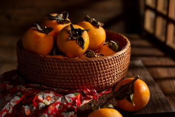 Fresh persimmon on a vintage wooden table