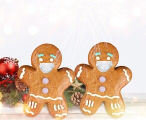 Stay home quarantine from Covid-19. Christmas gingerbread men with a masks
