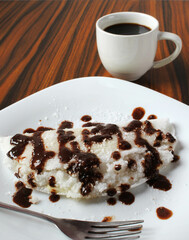 Closeup of sweet tapioca, chocolate and cooconut, black coffee cup in the background