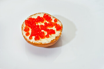 Sandwich with caviar and butter. Round sandwich on a white background.