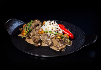 Meat in sauce and rice on a platter..