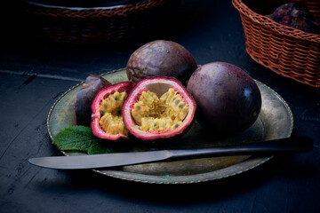 Fresh ripe passion fruits (maracuyas) on white background with water drops