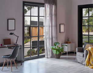 Modern rom with working table and armchair style, parquet floor, frame lamp decor, curtain, garden view house interior.