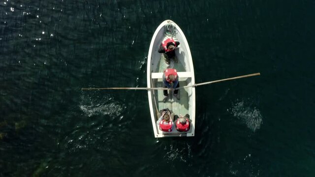Wooden Boat With People Rowing On Turquoise Water Near Flatey Island, Breidafjordur Bay, Iceland. Aerial Topdown