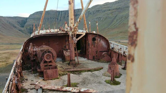 View of the deck and stern of the old rusty shipwreck Gardar BA 64 , beautiful landscape