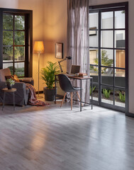 Modern rom with working table and armchair style, parquet floor, frame lamp decor, curtain, garden view house interior.