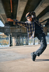 Stylish dancer dancing contemporary dance on the street urban background