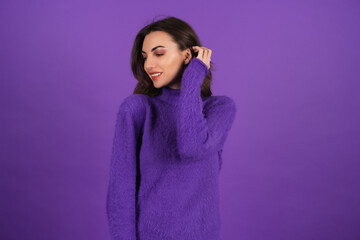 Young woman in a purple soft cozy sweater on the background of cute smiling cheerfully, in high spirits, confident smile, bright makeup with lipstick