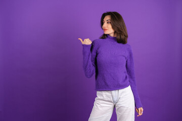 Young woman in a purple soft cozy sweater on a background of cute smiling cheerfully, in high...
