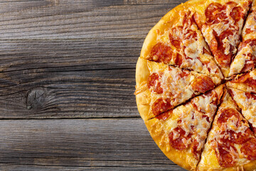 Tasty hot homemade pepperoni pizza. Traditional classic pizza with salami and cheese. Top view with copy space for text.