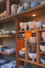 Side view of many various terracotta flower pots on wooden shelf decoration in vintage tone style and vertical frame 