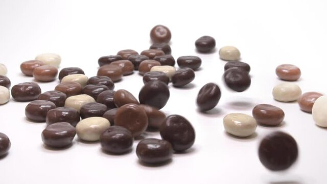 Chocolate kruitnoten (pepernoten): traditional Dutch candy. Falling slow motion. White background
