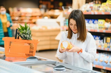Woman grocery shopping and looking very happy
