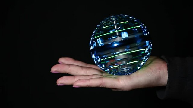 footage of spinner hand dark background