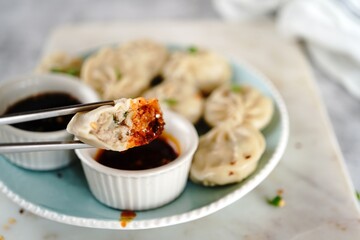 Chicken or Pork dumplings with soy and chilli sauce, selective focus