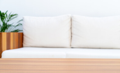 Fototapeta na wymiar Empty wooden Tabletop with white sofa in modern living Room