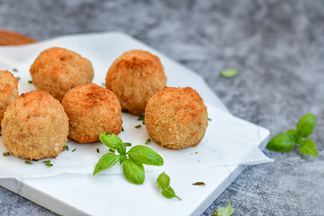 Italian arancini Cacio e pepe. Home-made rice balls with mozzarella cheese, parsley, lemon, and parmesan cheese.