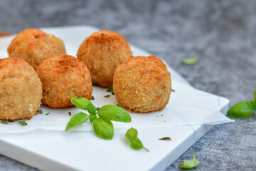 Italian arancini Cacio e pepe. Home-made rice balls with mozzarella cheese, parsley, lemon, and parmesan cheese.