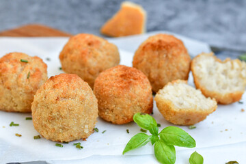 Italian arancini Cacio e pepe. Home-made rice balls with mozzarella cheese, parsley, lemon, and parmesan cheese.