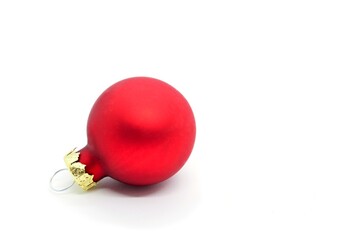 Red Christmas ornament ball on white background. Copy space on the right.