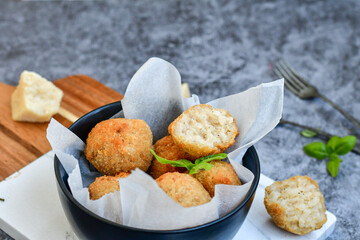 Italian arancini Cacio e pepe. Home-made rice balls with mozzarella cheese, parsley, lemon, and parmesan cheese.