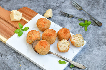 Italian arancini Cacio e pepe. Home-made rice balls with mozzarella cheese, parsley, lemon, and parmesan cheese.