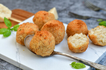 Italian arancini Cacio e pepe. Home-made rice balls with mozzarella cheese, parsley, lemon, and parmesan cheese.