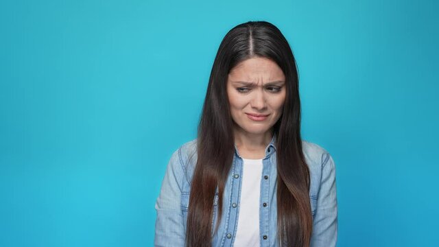Disappointed lady cover hand nose awfull smell isolated blue color background