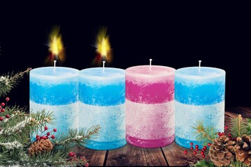 Burning candles with fire flame on dark background