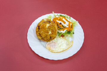 Bolón de verde is a typical Ecuadorian dish prepared with crushed green plantains and pieces of cheese or chicharrones