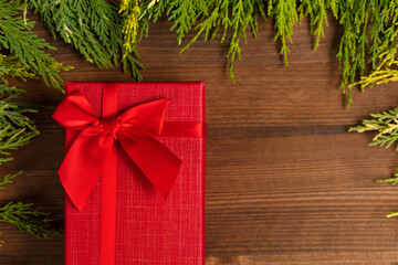 Christmas gift, christmas concept with christmas tree branches on wooden background.