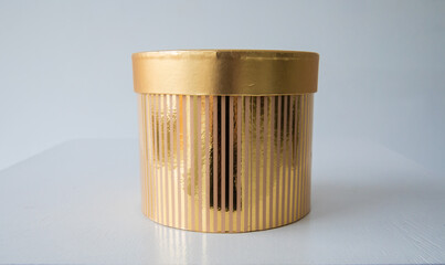 Close-up Craft Golden Cylindrical Gift Box Handmade on white background Copy Space