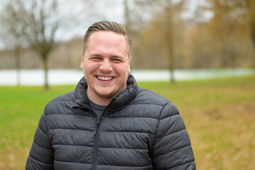 Happy young man grinning at the camera