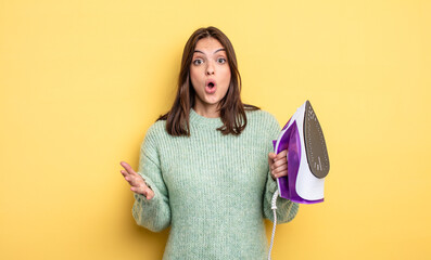 pretty woman amazed, shocked and astonished with an unbelievable surprise. iron clothes concept
