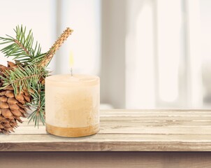 Fir branch with Christmas tinsel and candle. Christmas and New Year festive background.