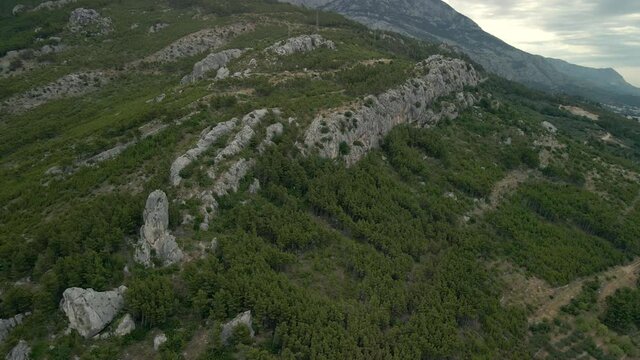 Babin zub. Big stone on the rocks of the Croatian coast cliffs. Croatia Makarska Riviera aerial view.