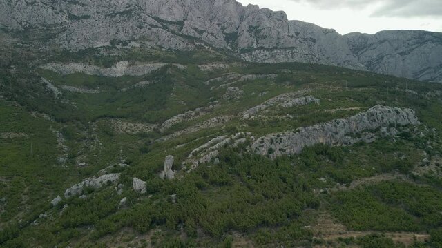 Babin zub. Big stone on the rocks of the Croatian coast cliffs. Croatia Makarska Riviera aerial view.