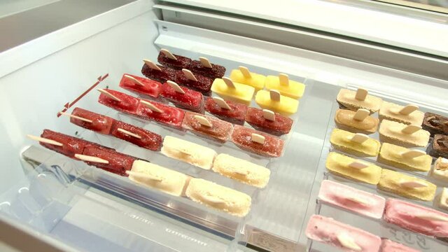A showcase of ice cream on sticks with different flavors