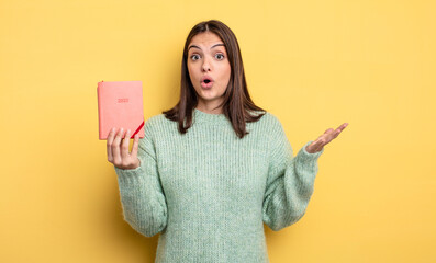 pretty woman amazed, shocked and astonished with an unbelievable surprise. planner concept