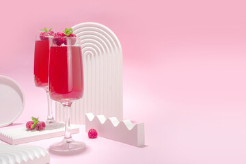 Red mimosas cocktail. Classic mimosa drink with raspberry juice, raspberry and mint decor. Summer bar menu concept, copy space