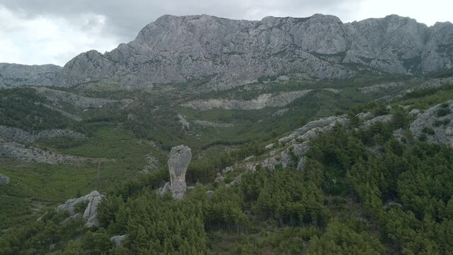 Babin zub. Big stone on the rocks of the Croatian coast cliffs. Croatia Makarska Riviera aerial view.