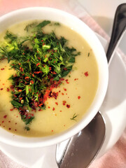 A plate of pea soup with spices on the table in the restaurant