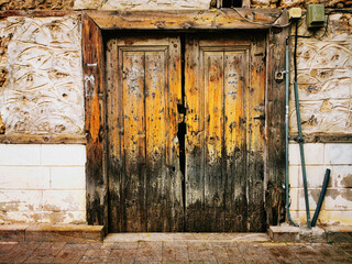 A view of an old cracked wooden door on the street