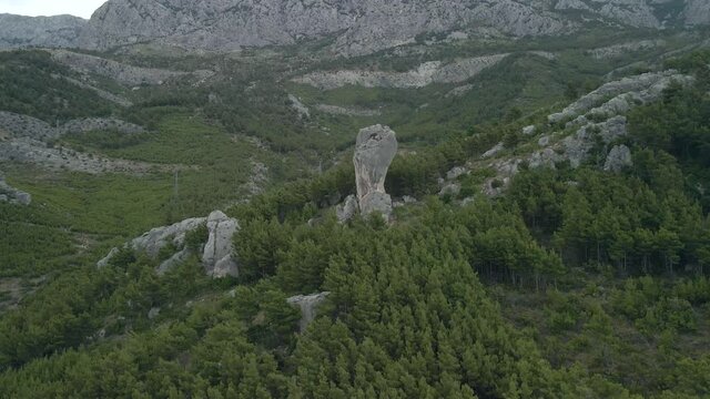 Babin zub. Big stone on the rocks of the Croatian coast cliffs. Croatia Makarska Riviera aerial view.