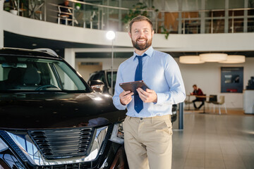 Portrait of successful male competent manager of dealership. Concept of expensive purchase.