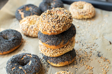 Homemade freshly baked bagels. with poppy seed and sesame. Close up.