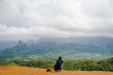 solo hiker man relax on top of mountain with his dog