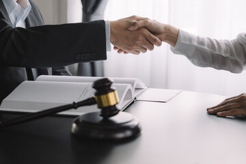 Judge gavel with Justice lawyers having team meeting at law firm background. Concepts of Law and...